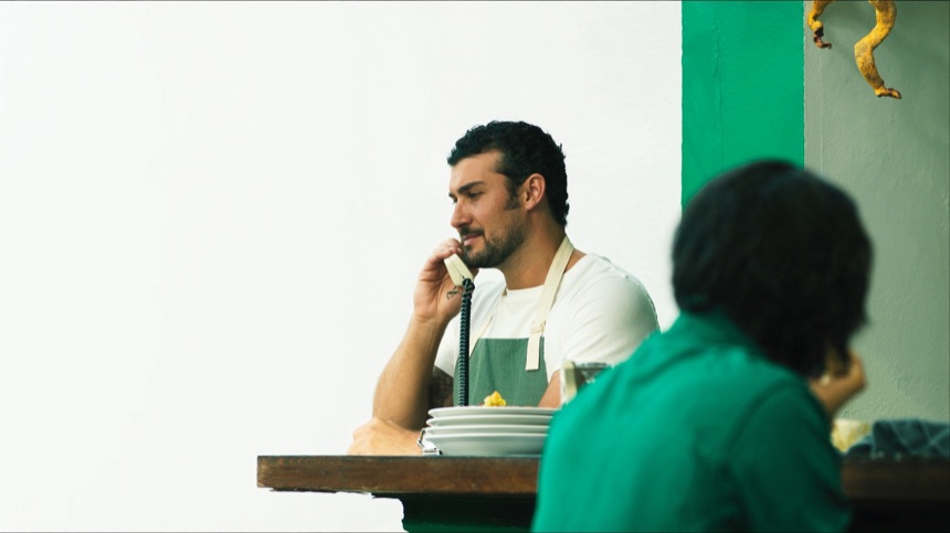 Restaurant owner taking a booking by phone during service